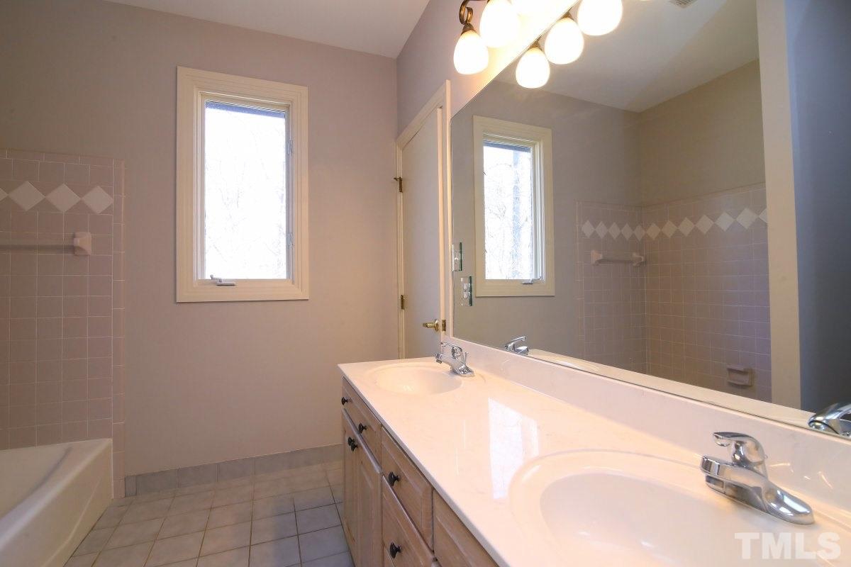 8800 Old Tom Way Raleigh, NC 27613 - Photo 11 of 25 a bathroom with a sink a vanity and a mirror