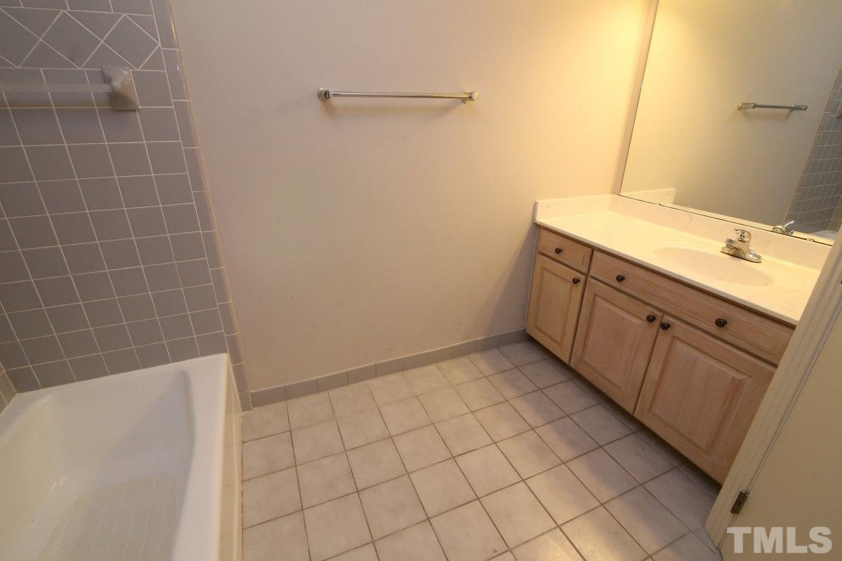 8800 Old Tom Way Raleigh, NC 27613 - Photo 17 of 25 a bathroom with a sink a toilet and a mirror