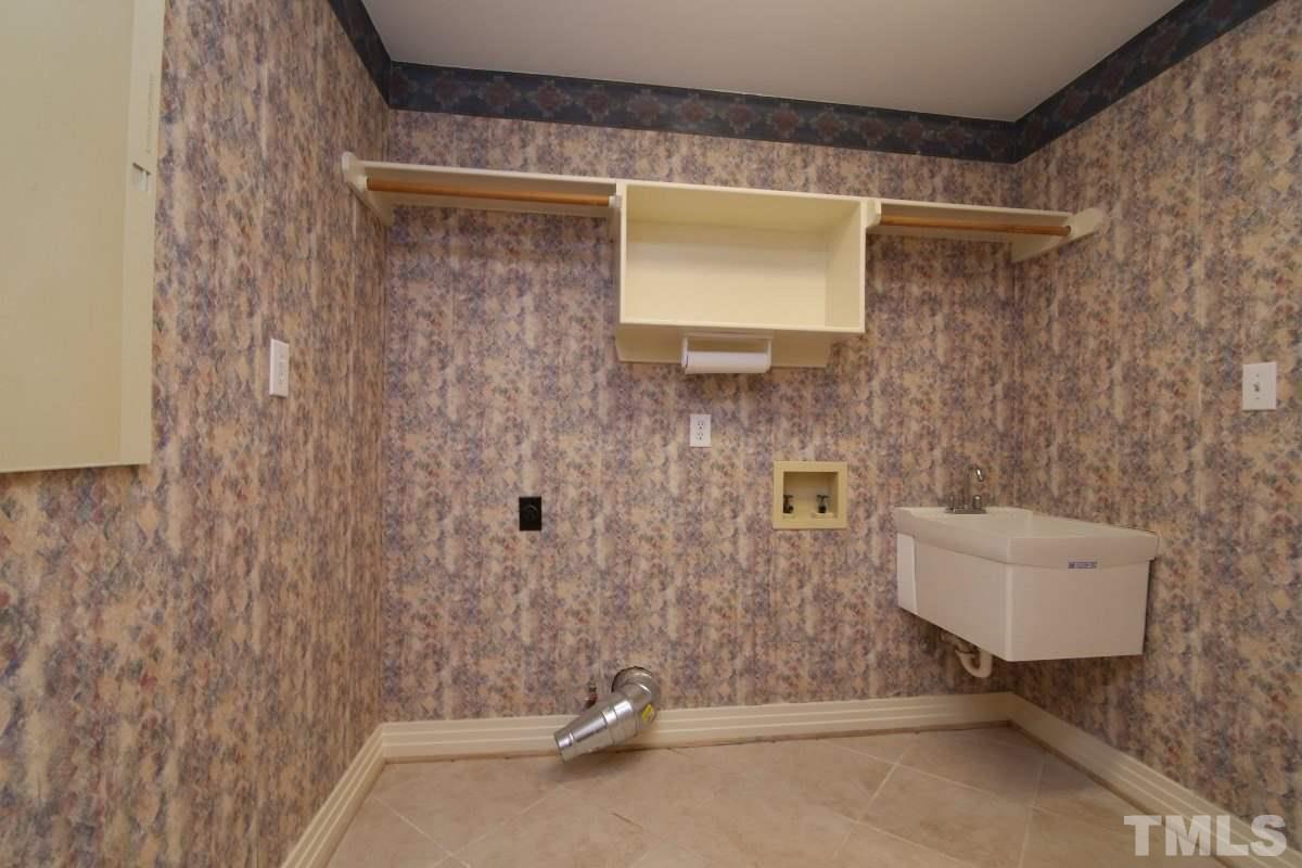 8800 Old Tom Way Raleigh, NC 27613 - Photo 19 of 25 a bathroom with a sink and a mirror