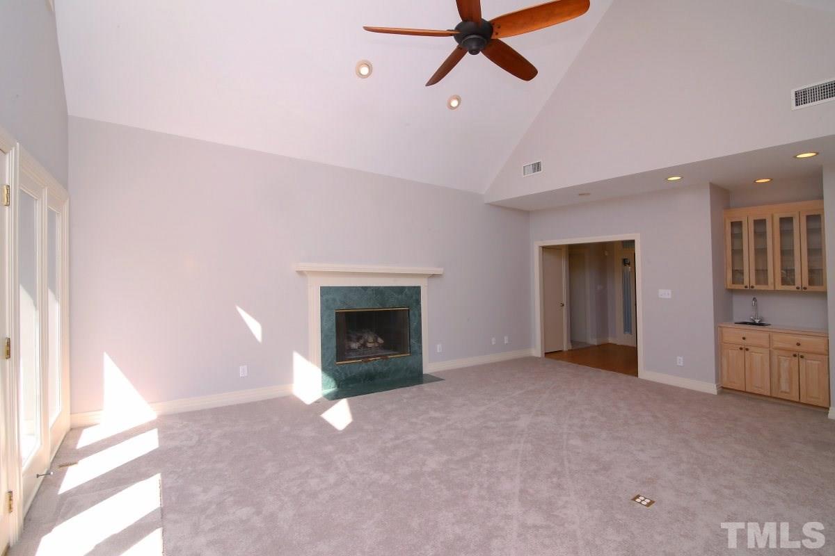 8800 Old Tom Way Raleigh, NC 27613 - Photo 3 of 25 a view of an empty room with a fireplace and a window