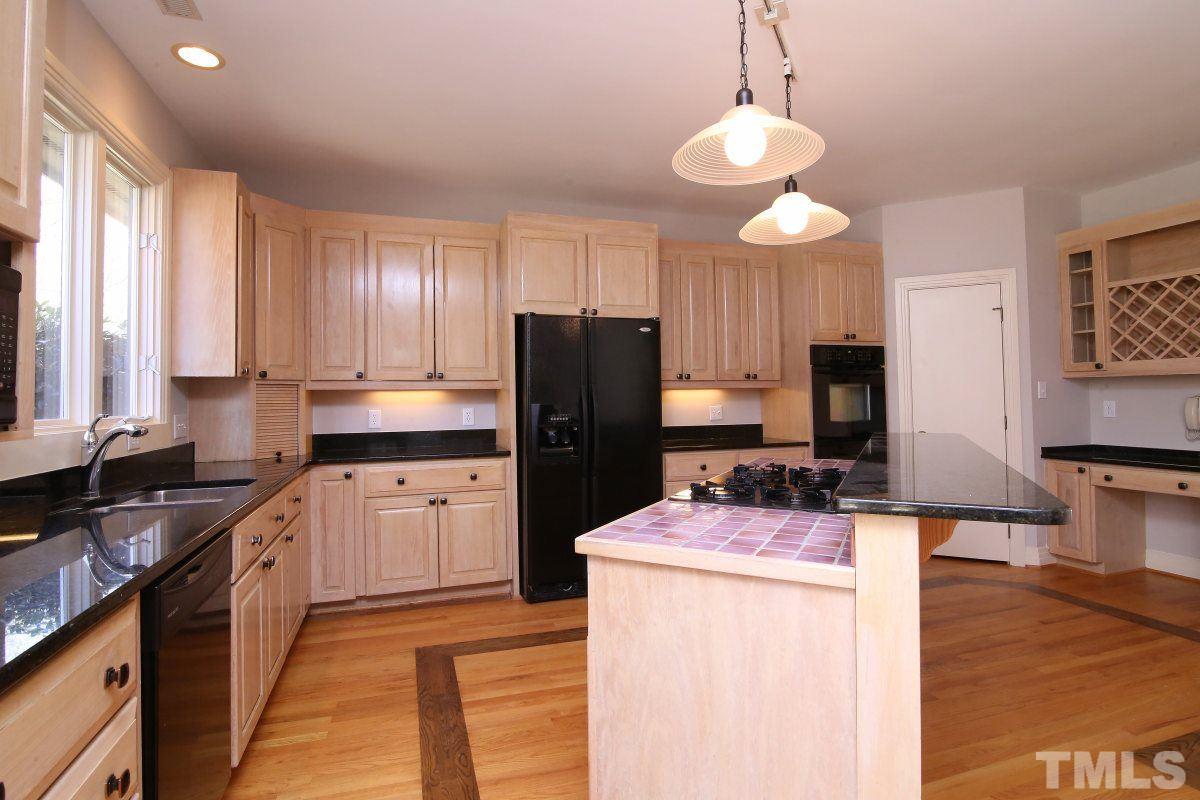 8800 Old Tom Way Raleigh, NC 27613 - Photo 4 of 25 a kitchen with a sink stove and refrigerator