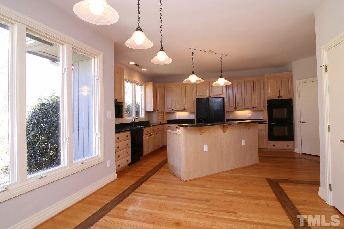 8800 Old Tom Way Raleigh, NC 27613 - Photo 5 of 25 a view of a kitchen with kitchen island a counter top space stainless steel appliances and a window