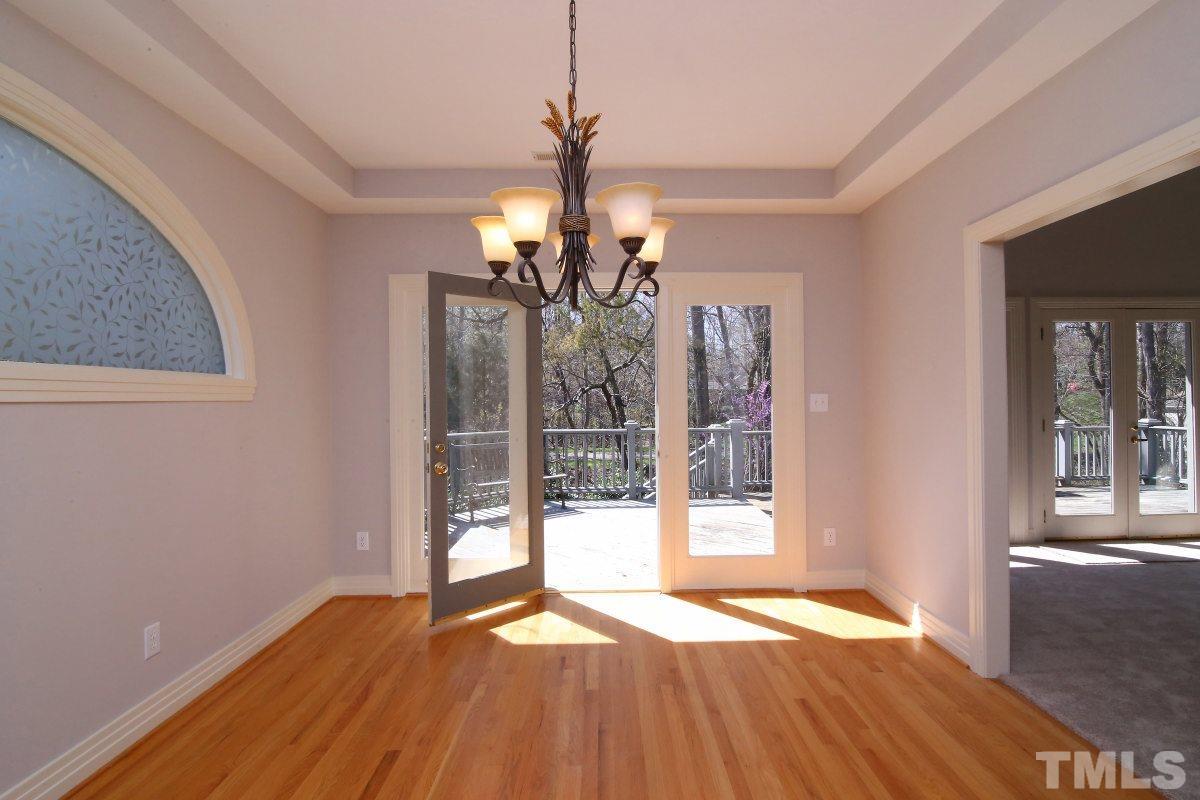 8800 Old Tom Way Raleigh, NC 27613 - Photo 7 of 25 a view of empty room with wooden floor and fan