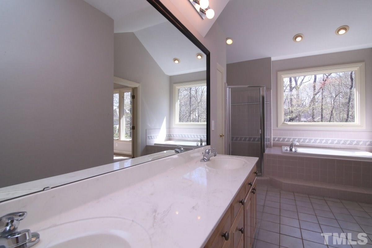 8800 Old Tom Way Raleigh, NC 27613 - Photo 9 of 25 a bathroom with a tub sink and mirror