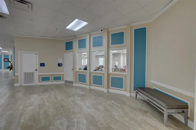 a room with lots of furniture a wooden table and chairs