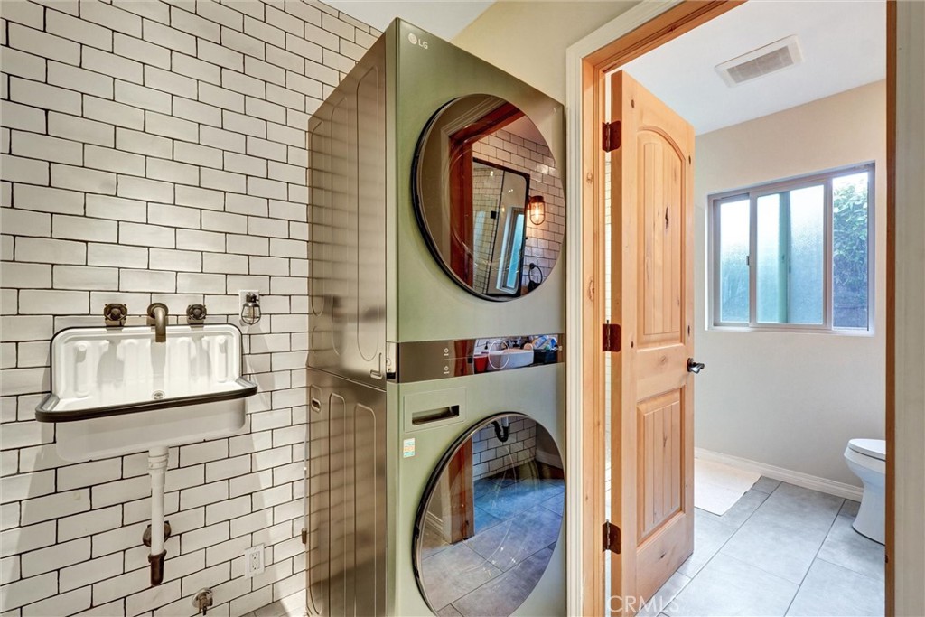 14955 Haynes Street Van Nuys, CA 91411 - Photo 15 of 35 a bathroom with a sink a mirror and a shower
