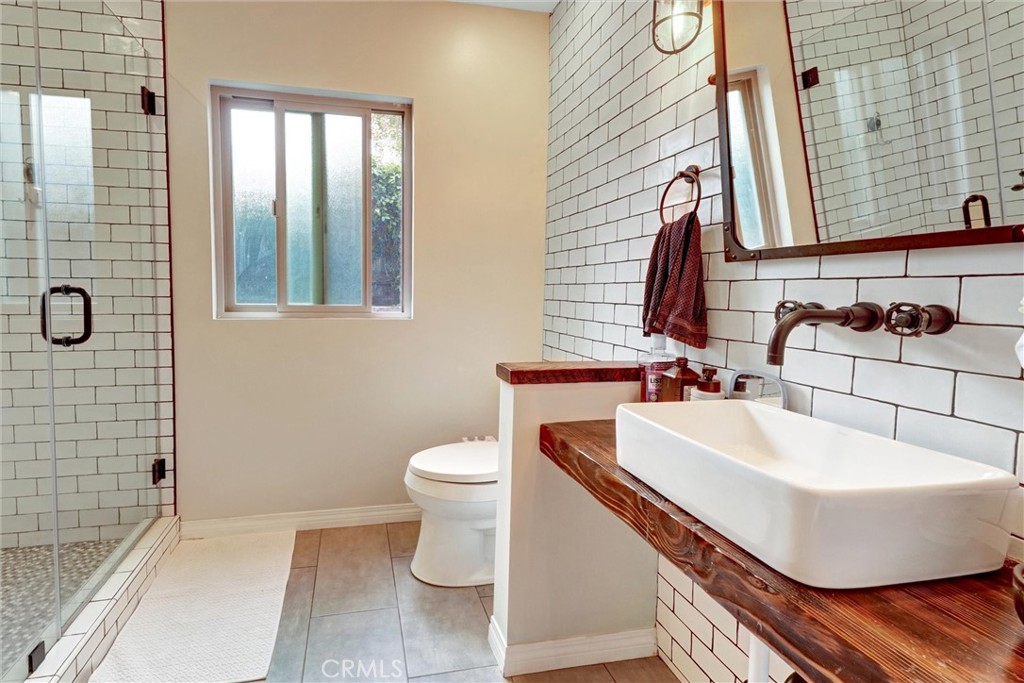 14955 Haynes Street Van Nuys, CA 91411 - Photo 23 of 35 a bathroom with a sink a toilet and shower