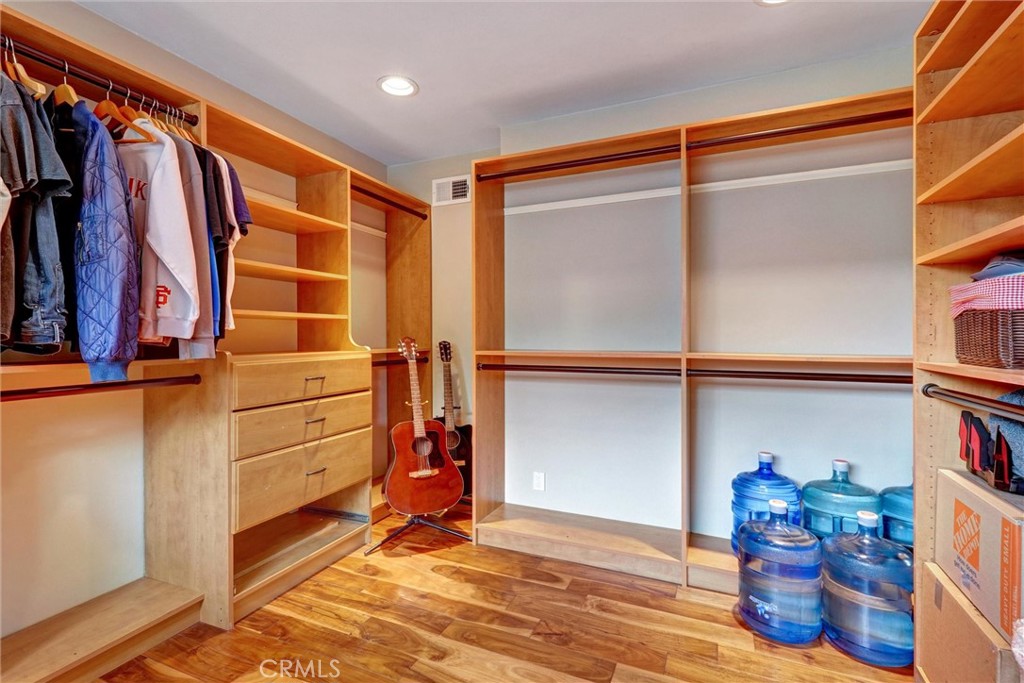 14955 Haynes Street Van Nuys, CA 91411 - Photo 24 of 35 a view of walk in closet with clothes and shoes