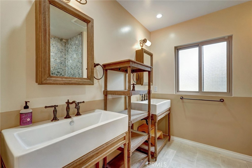 14955 Haynes Street Van Nuys, CA 91411 - Photo 25 of 35 a bathroom with a sink and a mirror