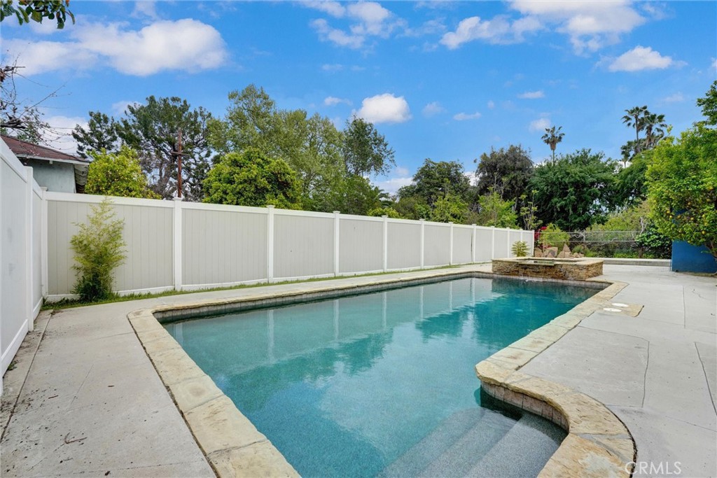 14955 Haynes Street Van Nuys, CA 91411 - Photo 27 of 35 a view of a swimming pool with a yard