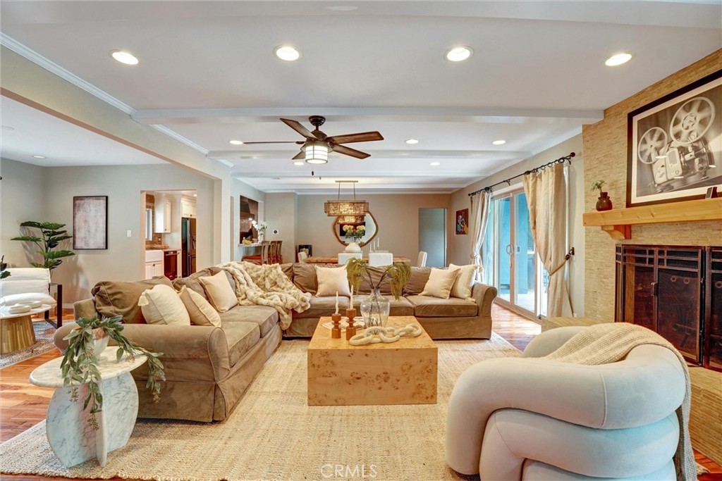14955 Haynes Street Van Nuys, CA 91411 - Photo 7 of 35 a living room with furniture ceiling fan and a fireplace