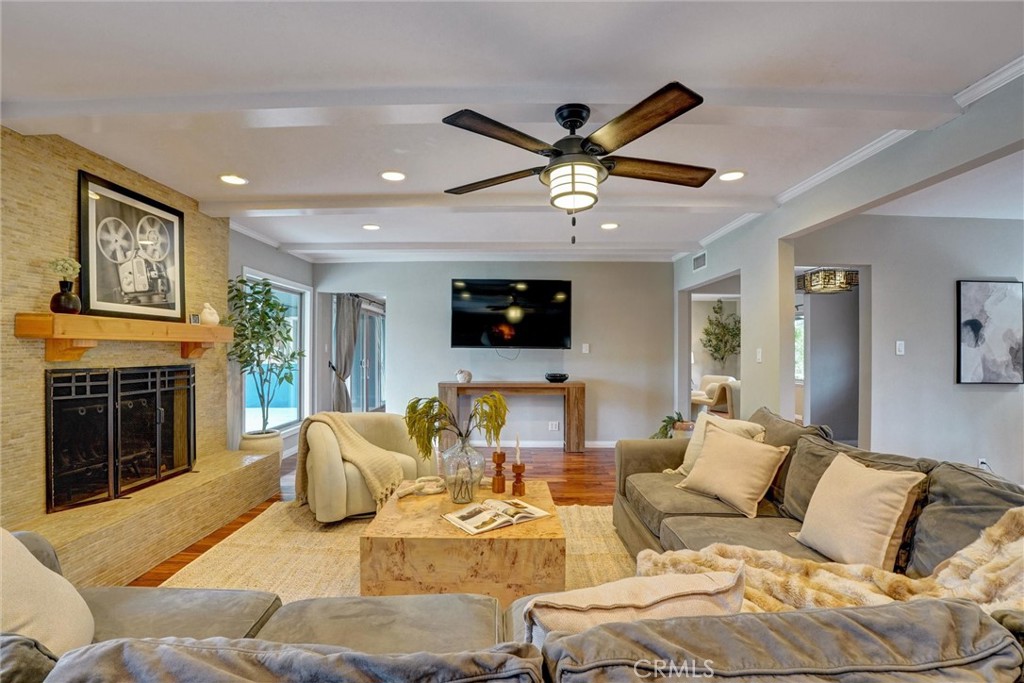 14955 Haynes Street Van Nuys, CA 91411 - Photo 8 of 35 a living room with furniture a fireplace and a flat screen tv