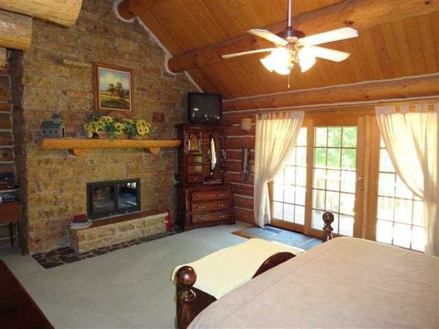 1373 South Snipe Hollow Road Elizabeth, IL 61028 - Photo 6 of 12 a bed room with a bed and a fireplace