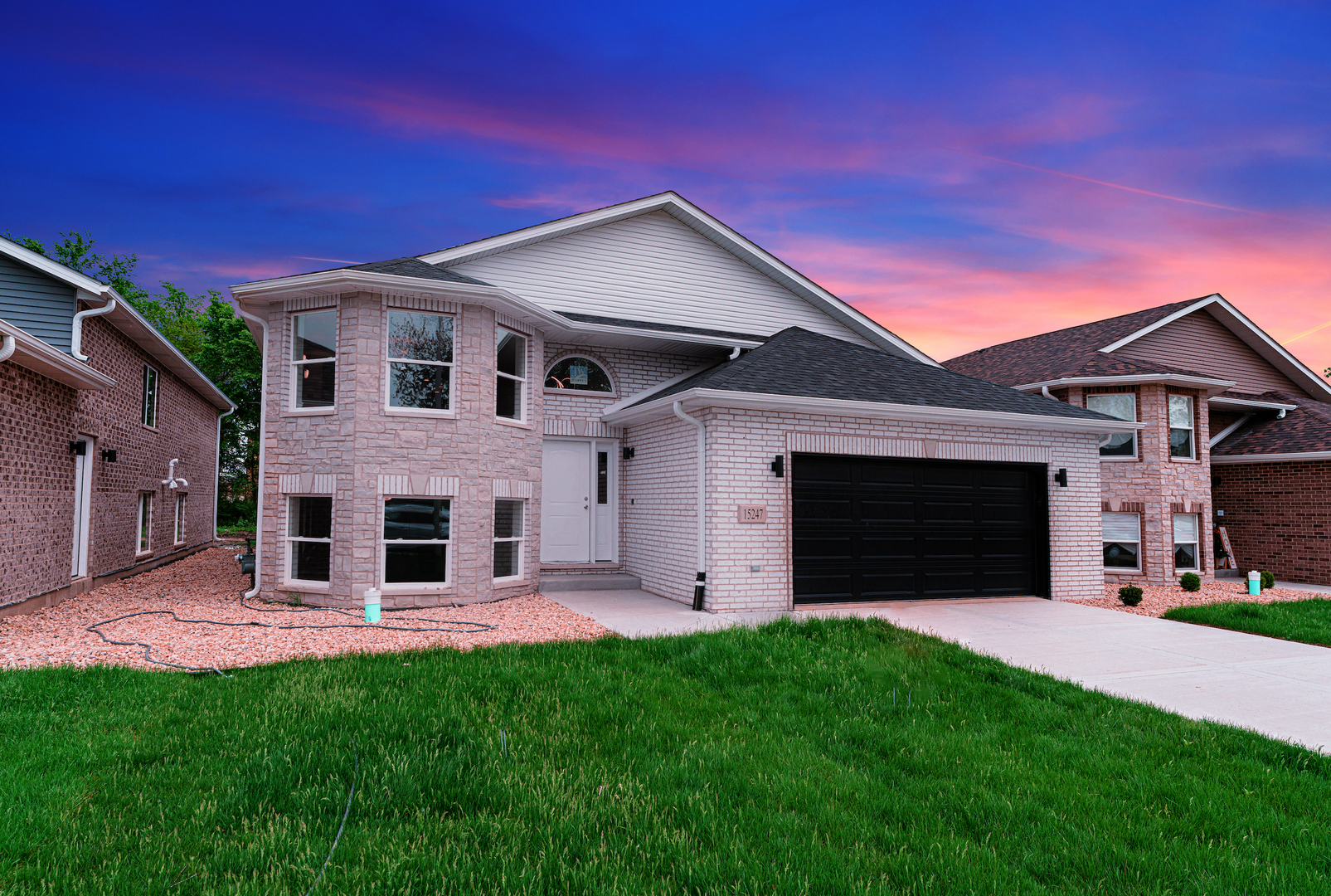 15247 7th Avenue Harvey, IL 60426 - Photo 1 of 1 a front view of a house with a yard and garage