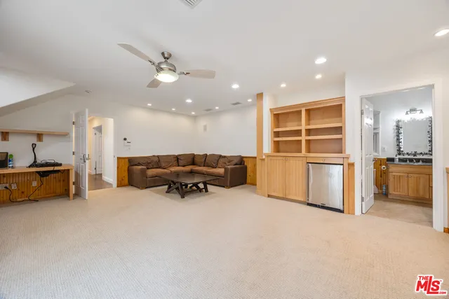 a kitchen with furniture and a refrigerator