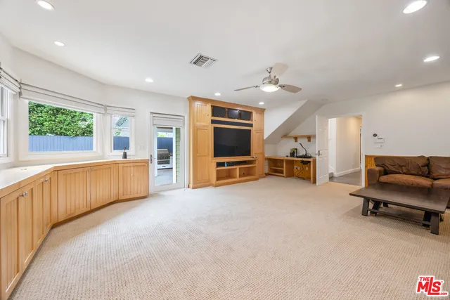 a large living room with furniture and a flat screen tv