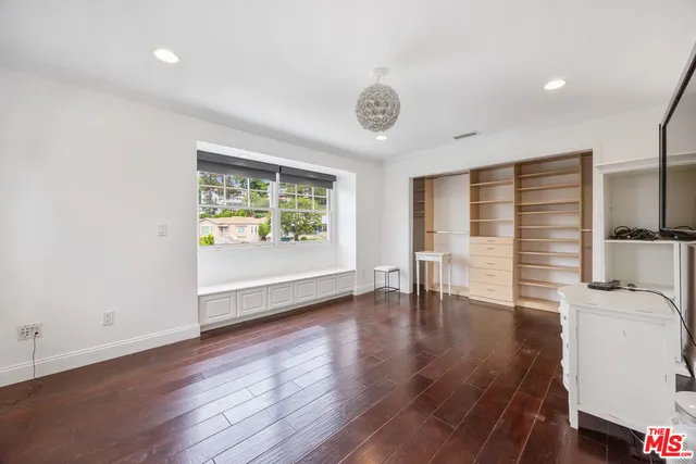 a bathroom with a double vanity sink a toilet and shower