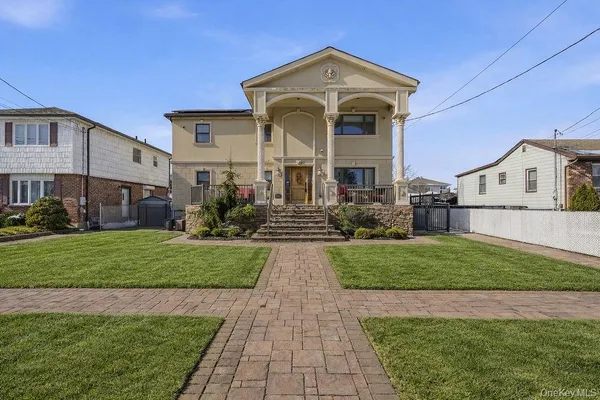 a front view of a house with garden