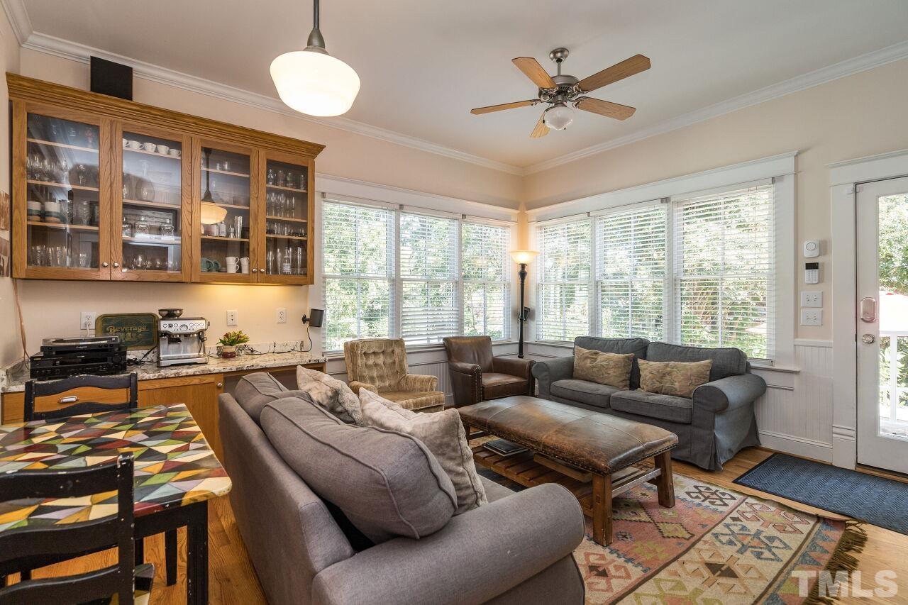 1218 Filmore Street Raleigh, NC 27605 - Photo 17 of 38 a living room with furniture ceiling fan and a large window