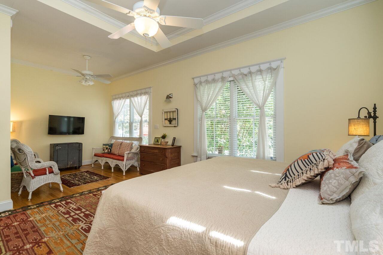 1218 Filmore Street Raleigh, NC 27605 - Photo 20 of 38 a bedroom with a bed and wooden floor