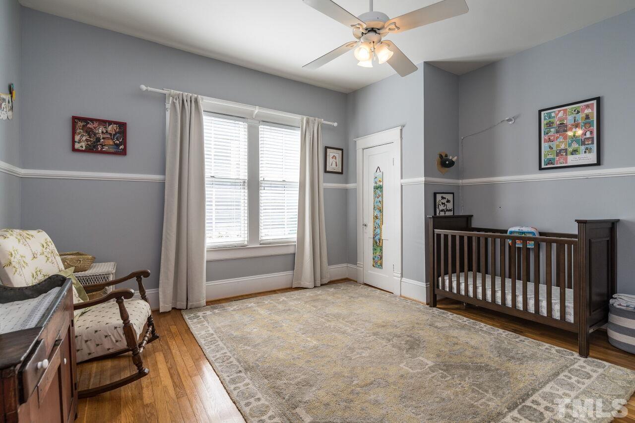 1218 Filmore Street Raleigh, NC 27605 - Photo 23 of 38 a view of a bedroom with furniture window and wooden floor