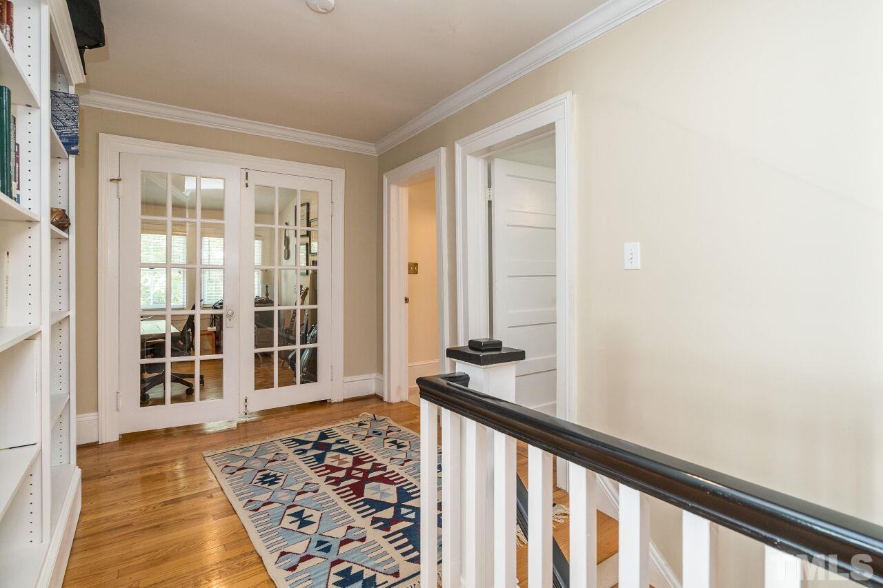 1218 Filmore Street Raleigh, NC 27605 - Photo 26 of 38 a view of a bedroom with wooden floor and windows