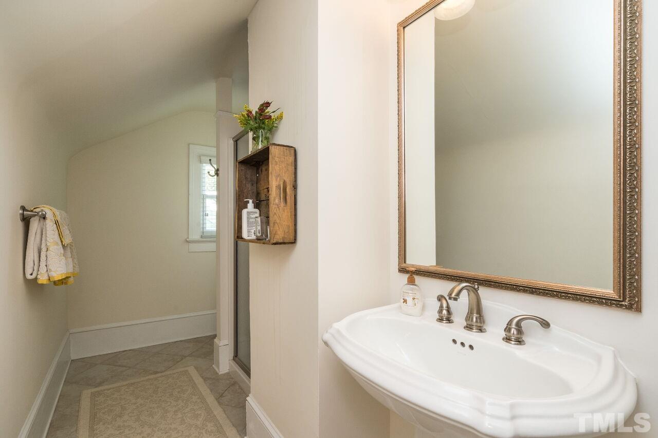 1218 Filmore Street Raleigh, NC 27605 - Photo 30 of 38 a bathroom with a sink and a mirror