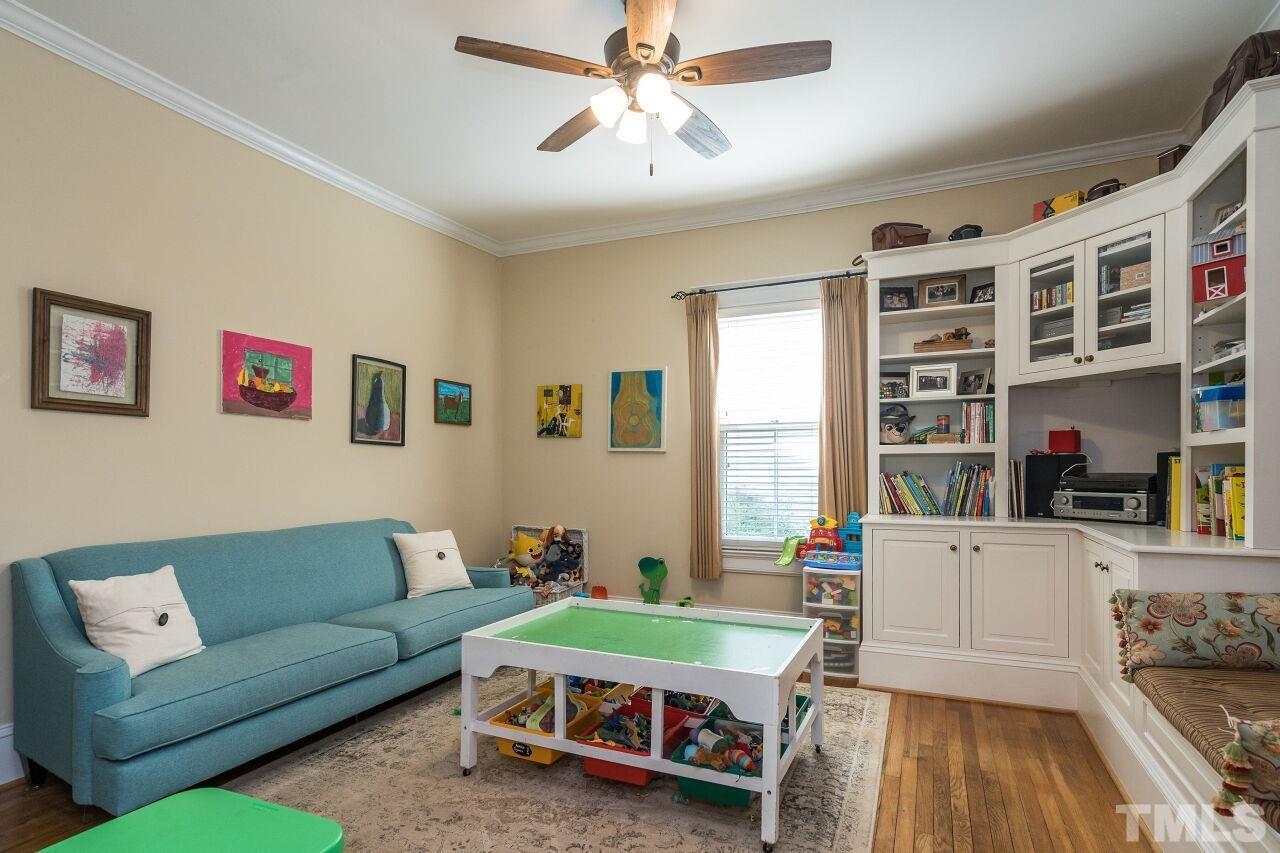 1218 Filmore Street Raleigh, NC 27605 - Photo 7 of 38 a living room with furniture and a book shelf