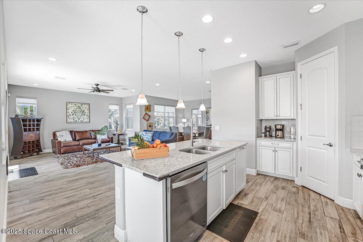 3379 Ribbon Grass Drive Melbourne, FL 32940 - Photo 21 of 62 a kitchen with a sink and living room view