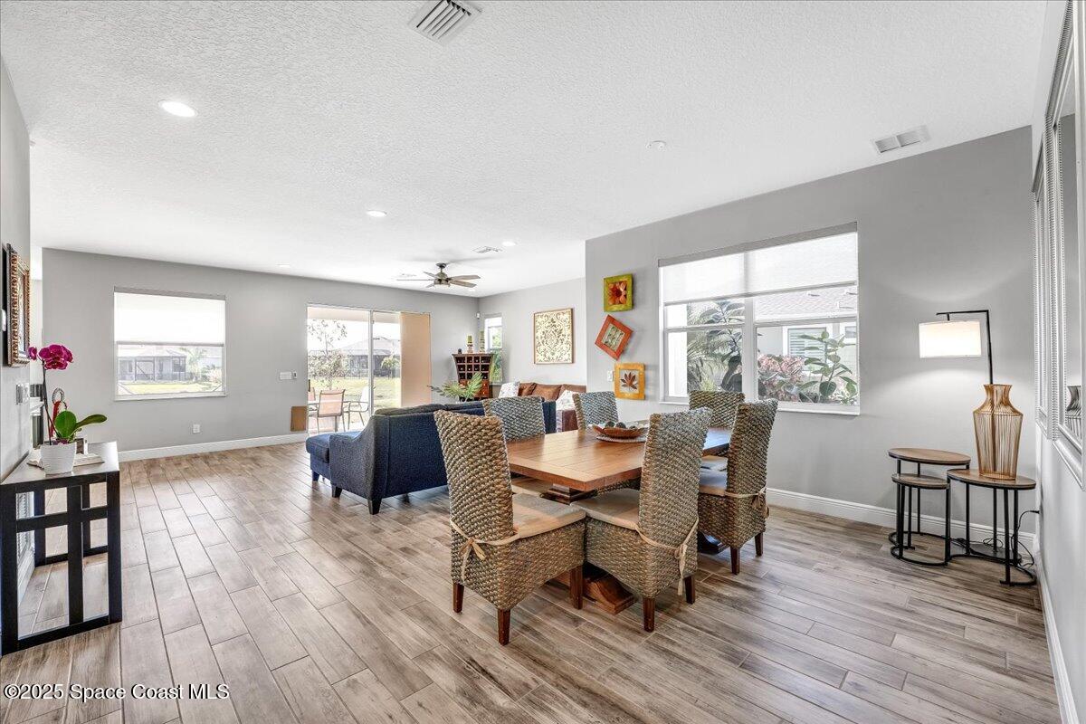 3379 Ribbon Grass Drive Melbourne, FL 32940 - Photo 10 of 62 a view of a dining room with furniture and wooden floor