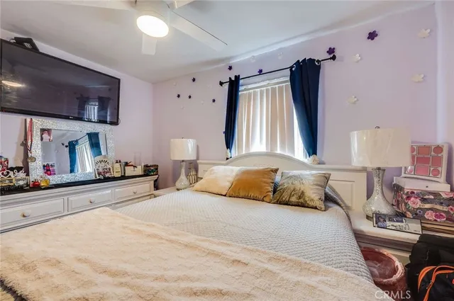 a bedroom with a bed and a mirror