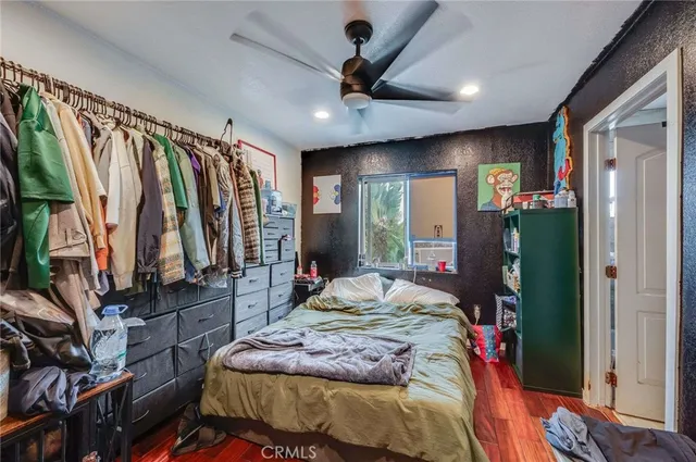 a bedroom with a bed and a flat tv screen