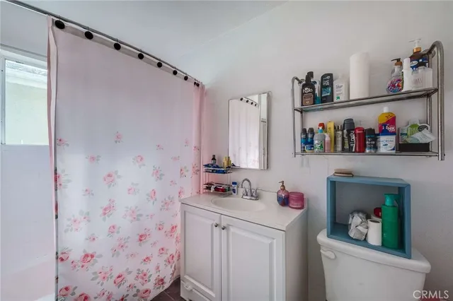 a bathroom with a sink vanity mirror and toilet