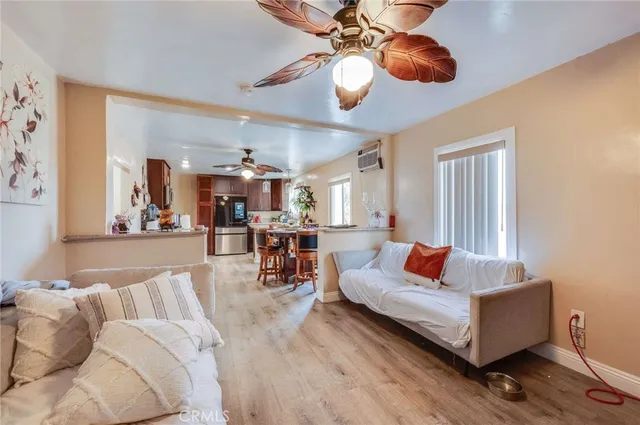 a living room with furniture and kitchen view
