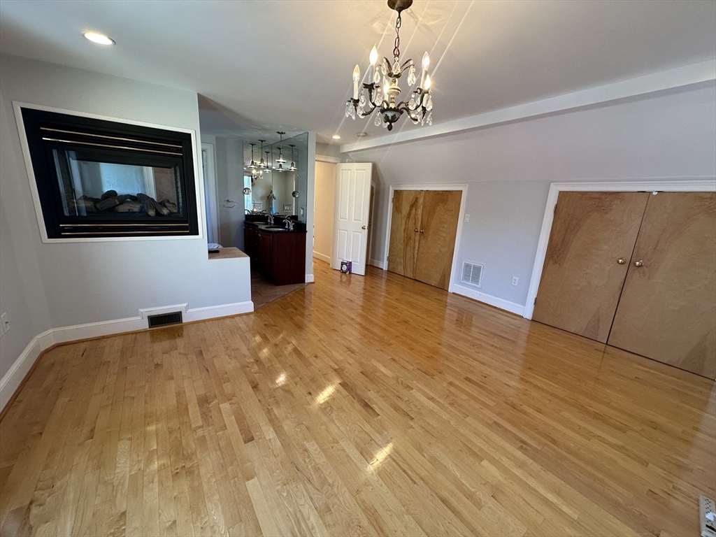 17 Herbert Road, Unit 1 Arlington, MA 02474 - Photo 23 of 26 a view of a room with wooden floor and staircase