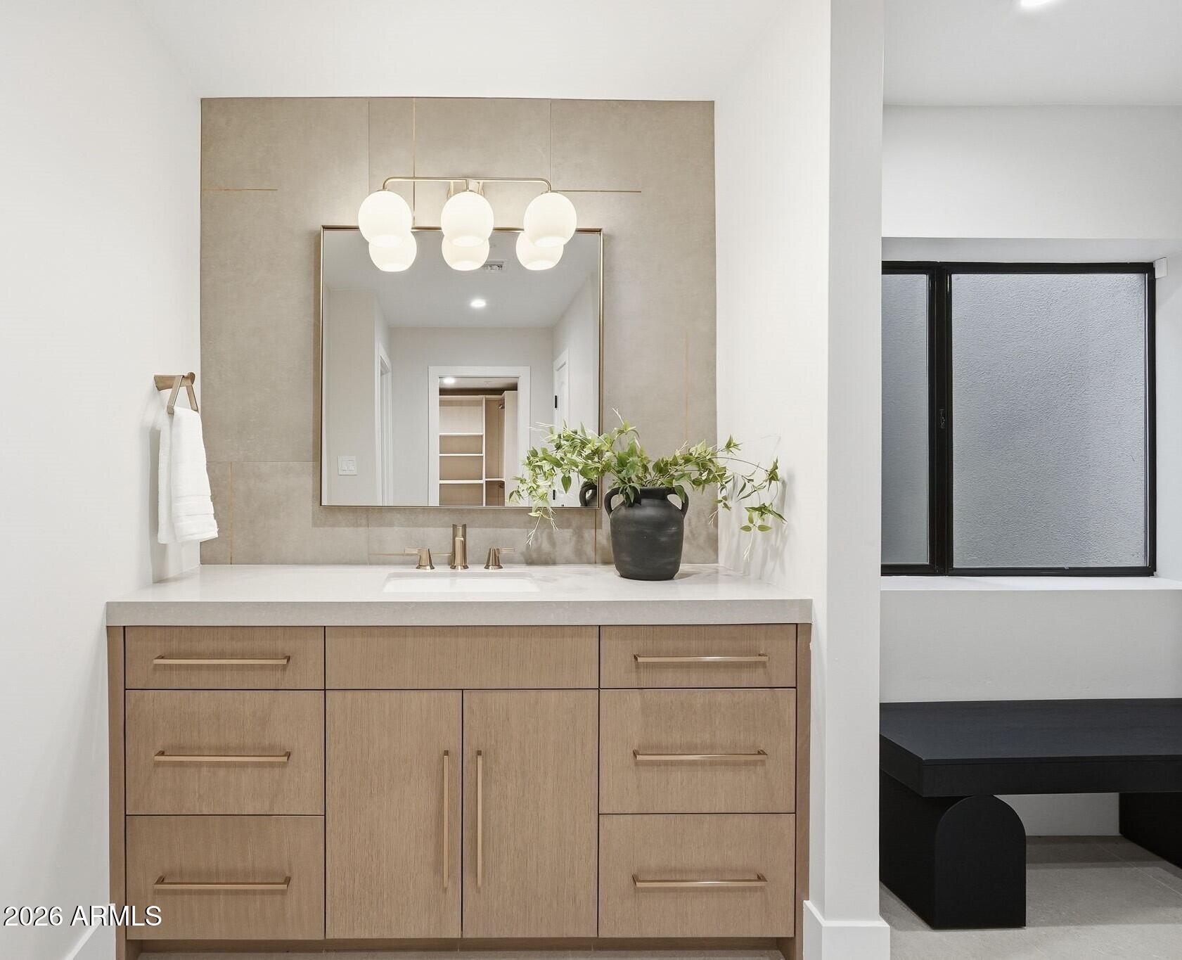 7475 East Gainey Ranch Road, Unit 7 Scottsdale, AZ 85258 - Photo 60 of 77 a bathroom with a sink and a mirror