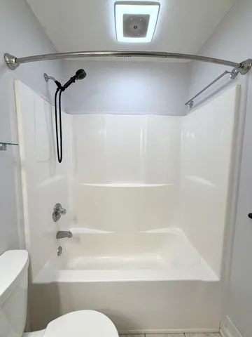 a bathroom with a shower and a toilet
