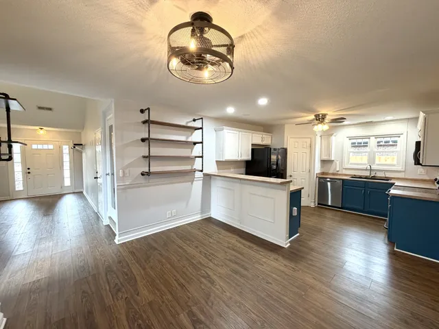 a view of a kitchen with stove and cabinets