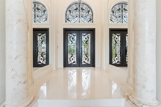 a dining room with furniture a chandelier and wooden floor