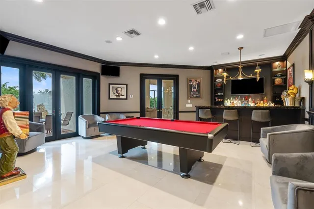 a living room with a large window and dining table