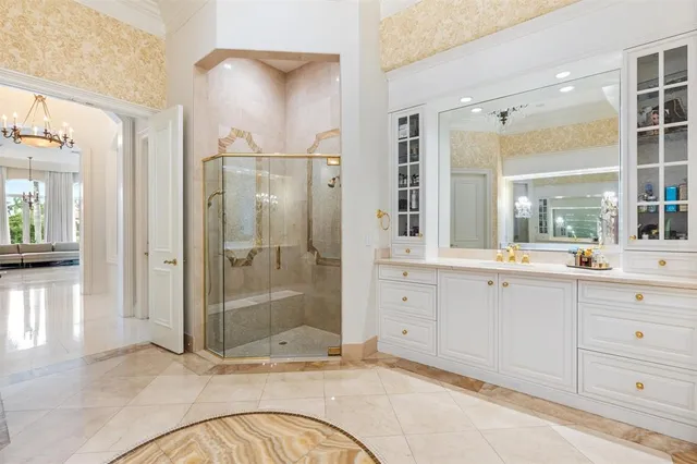 a bathroom with a granite countertop toilet sink and mirror