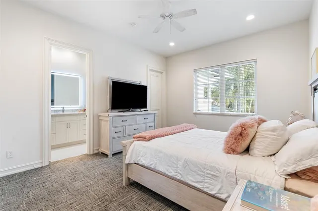 a living room with large couches chandelier and a large window