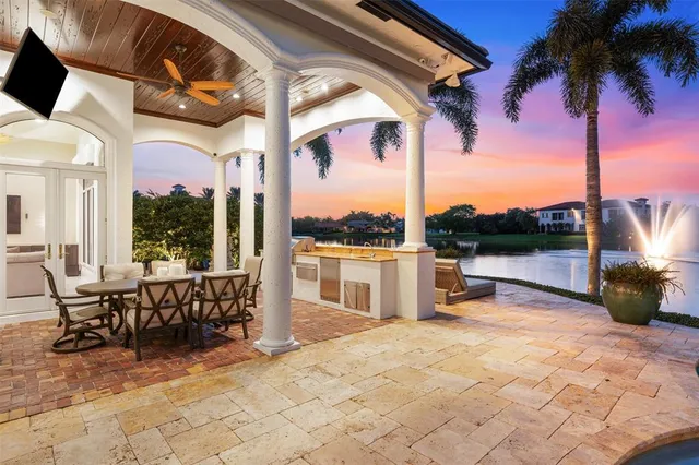 a living room with fireplace furniture and a large window