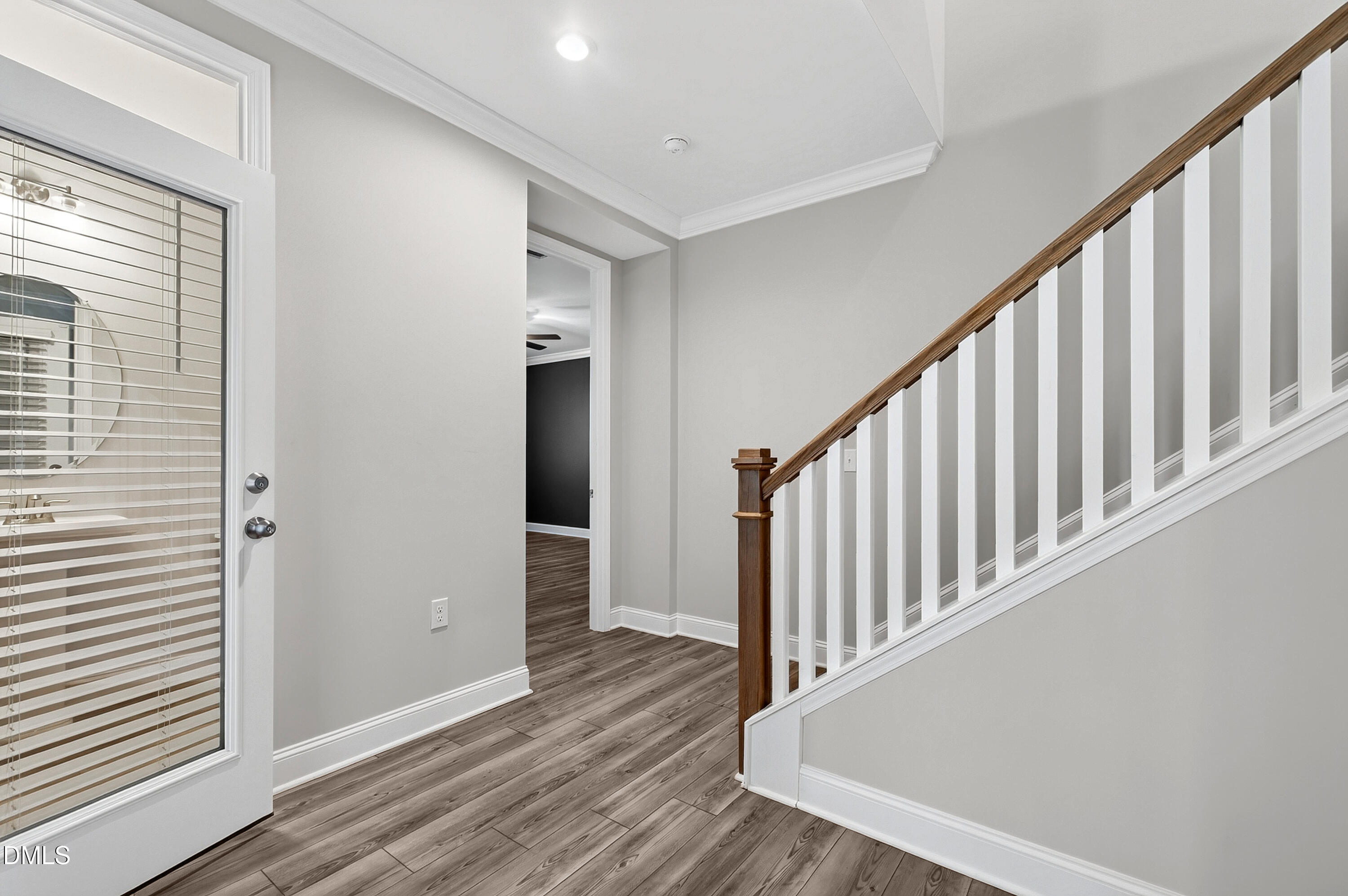 1300 Commons Ford Place Apex, NC 27539 - Photo 43 of 70 a view of a hallway with wooden floor and staircase