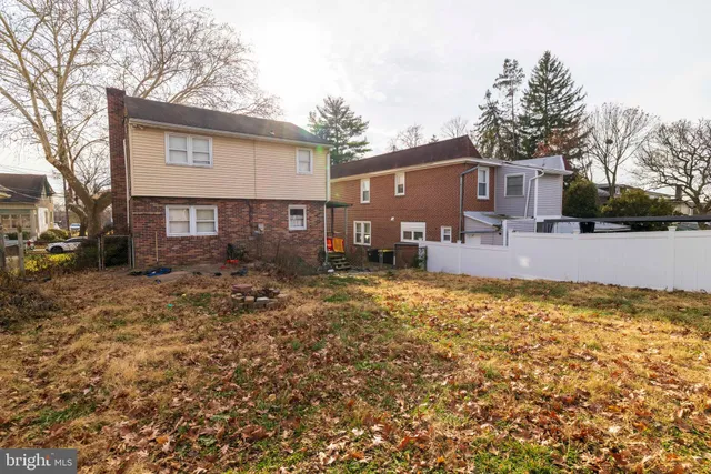 a view of a house with a yard covered in snow