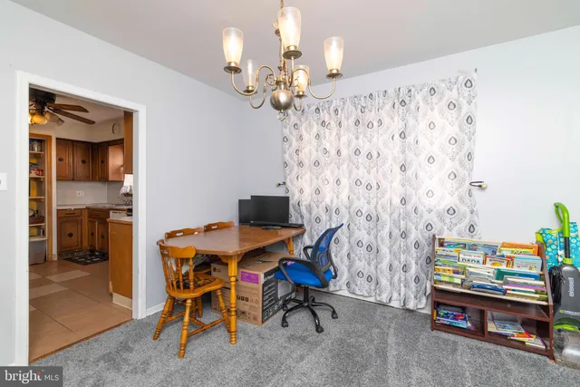 a view of a dining room with furniture and chandelier