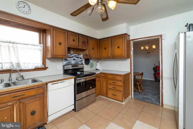 a kitchen with stainless steel appliances granite countertop a stove and a sink