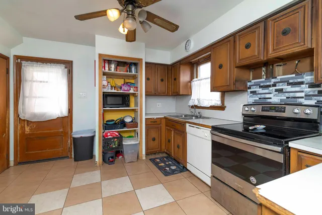 a kitchen with stainless steel appliances granite countertop a stove and cabinets