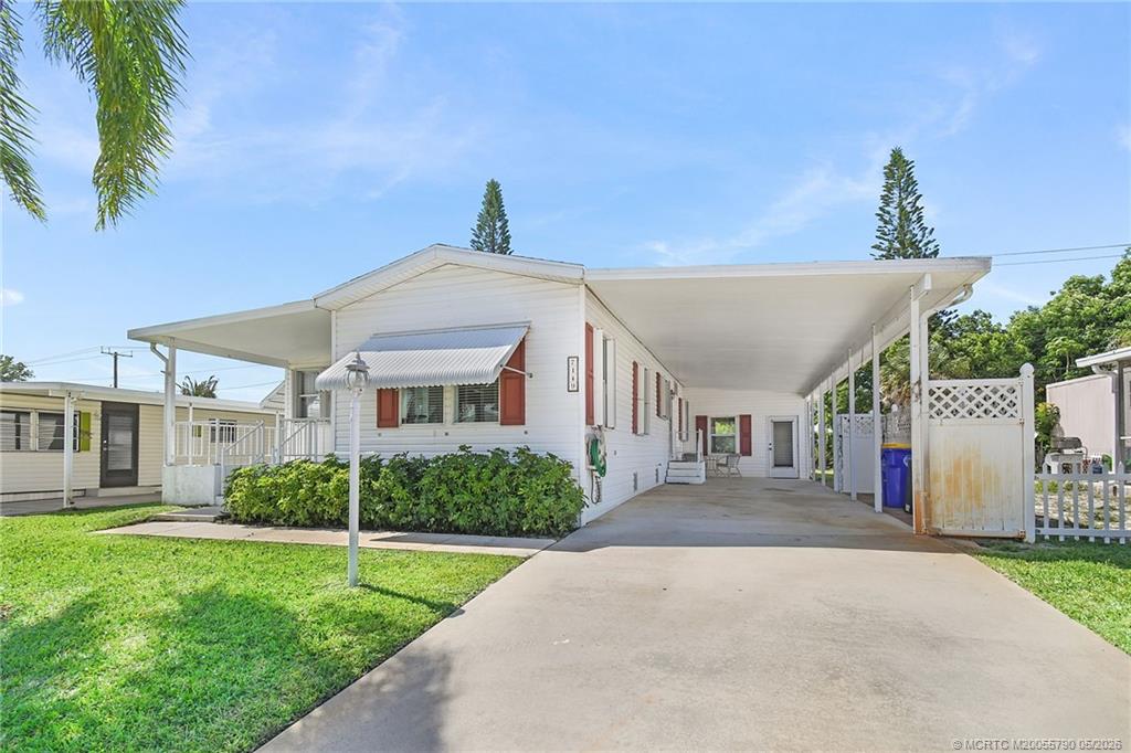 7149 Southeast Ridgeway Terrace Hobe Sound, FL 33455 - Photo 3 of 34 Large carport and plenty of extra space in driveway
