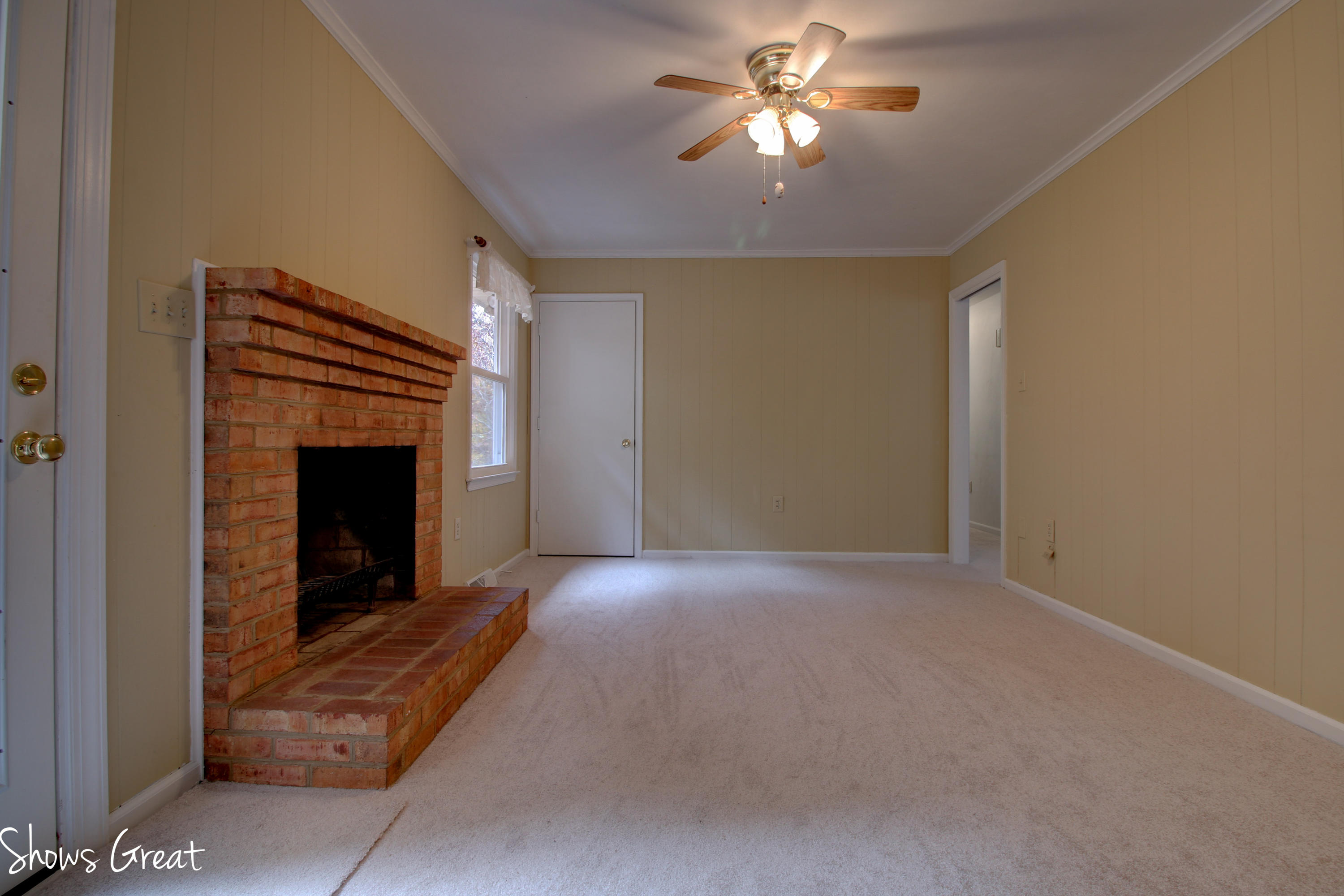 36 Spruce Lane Blue Ridge, VA 24064 - Photo 15 of 35 a view of empty room with a fireplace and a chandelier fan